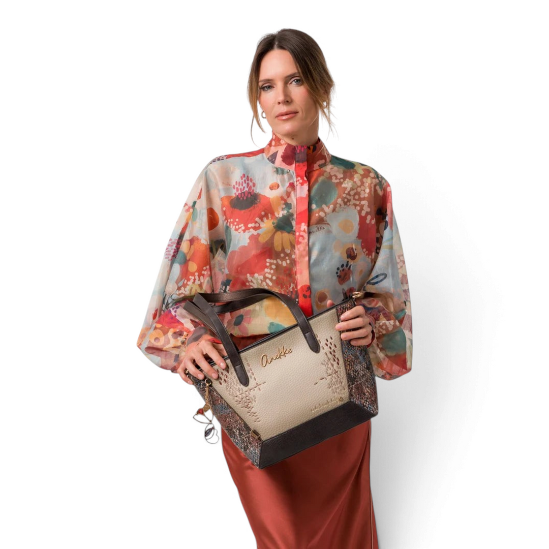 ada-shoes.ro Anekke Core shopper bag in beige and bronze with artistic prints, held by a model in a floral blouse
